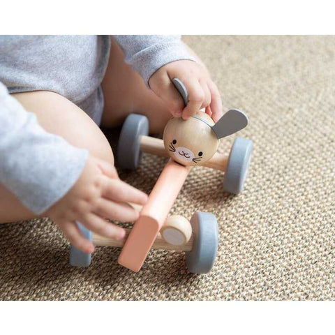 Kid playing PlanToys Chicken Racing Car