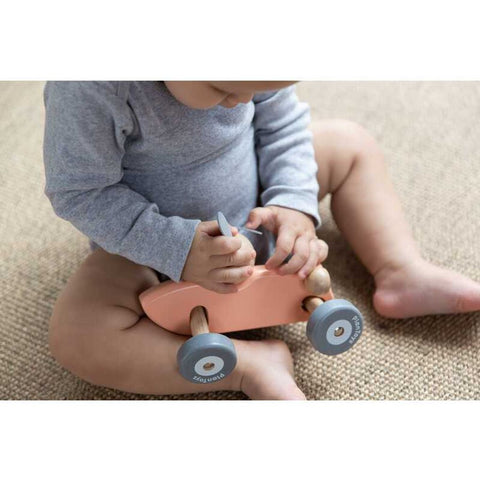 Kid playing PlanToys Bunny Racing Car