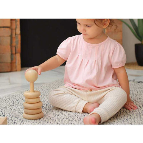 Kid playing PlanToys Stacking Ring - Natural