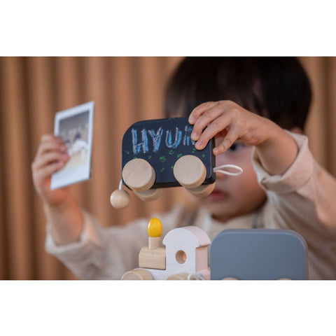 Kid playing PlanToys Celebration Train