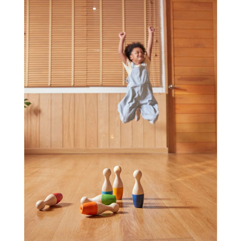 Kid playing PlanToys Bowling Set