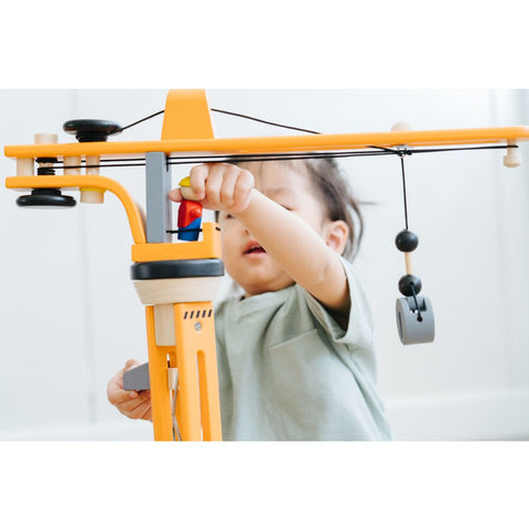 Kid playing PlanToys Crane Set