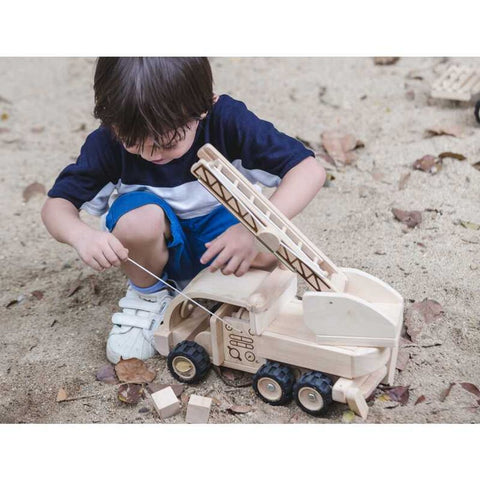 Kid playing PlanToys Fire Truck