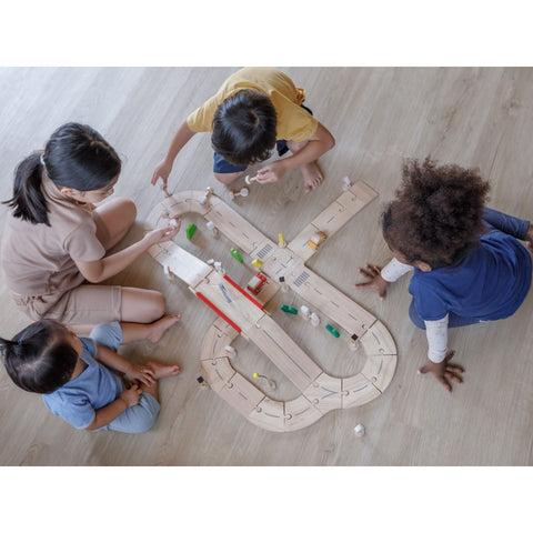 Kid playing PlanToys Road System