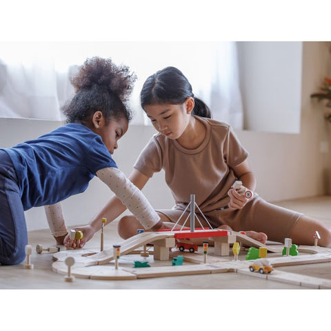 Kid playing PlanToys Road System