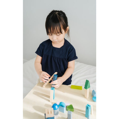 Kid playing PlanToys Urban City Blocks