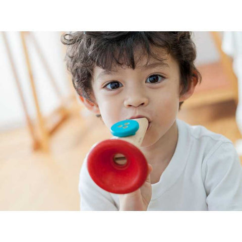 Kid playing PlanToys Kazoo