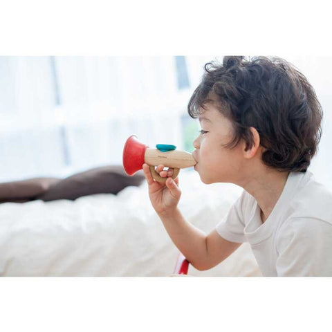 Kid playing PlanToys Kazoo