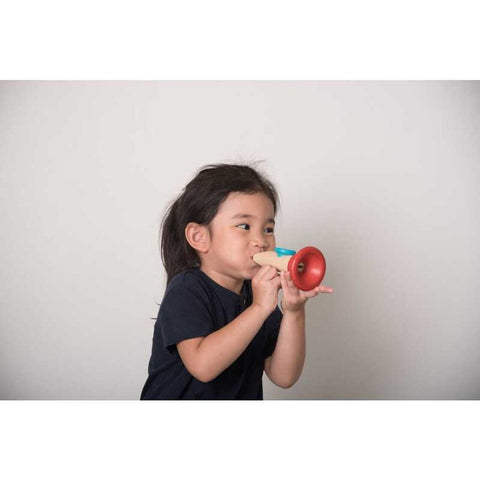 Kid playing PlanToys Kazoo