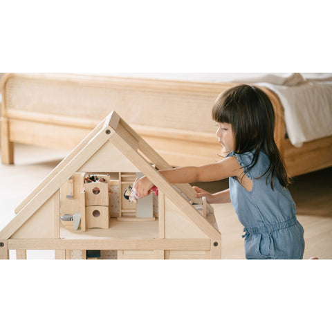 Kid playing PlanToys My First Dollhouse