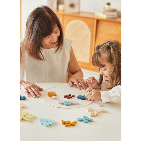 Family playing PlanToys Mandala