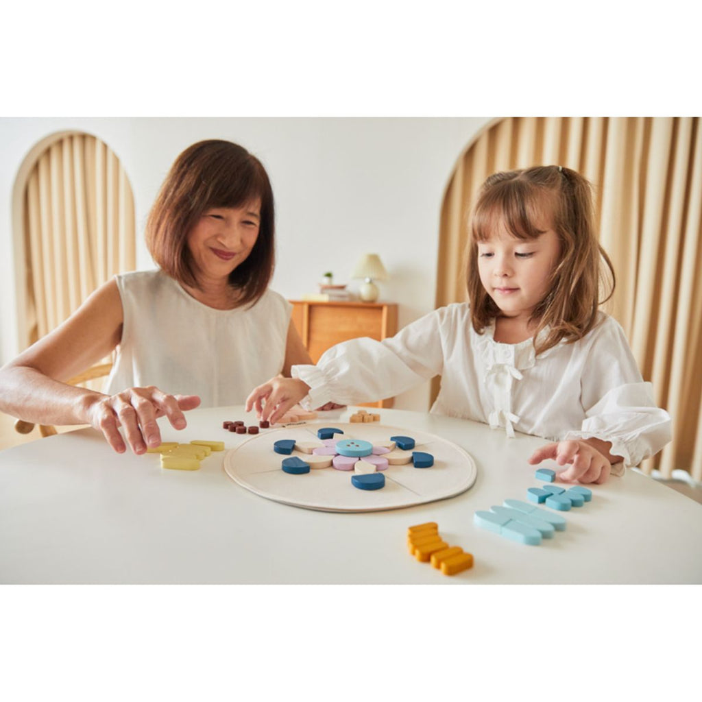 Family playing PlanToys Mandala