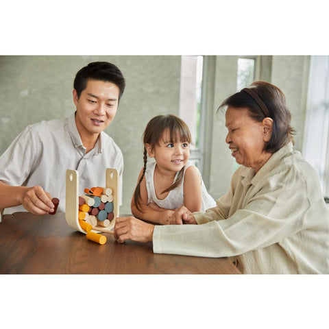 Family playing PlanToys Beaver Tumble