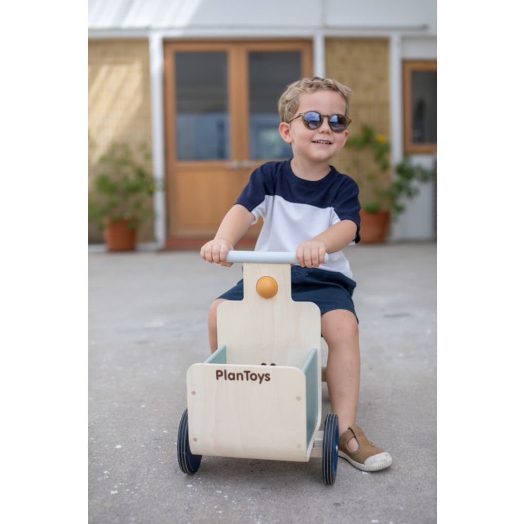 Kid playing PlanToys Delivery Bike - Orchard Collection