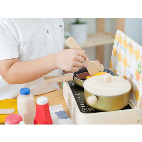 Kid playing PlanToys Cooking Utensils Set