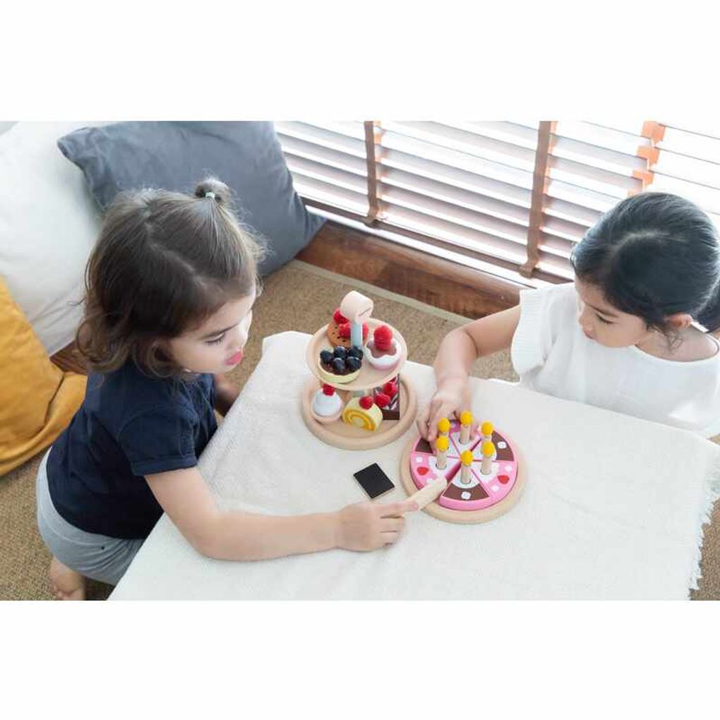 Kid playing PlanToys Birthday Cake Set