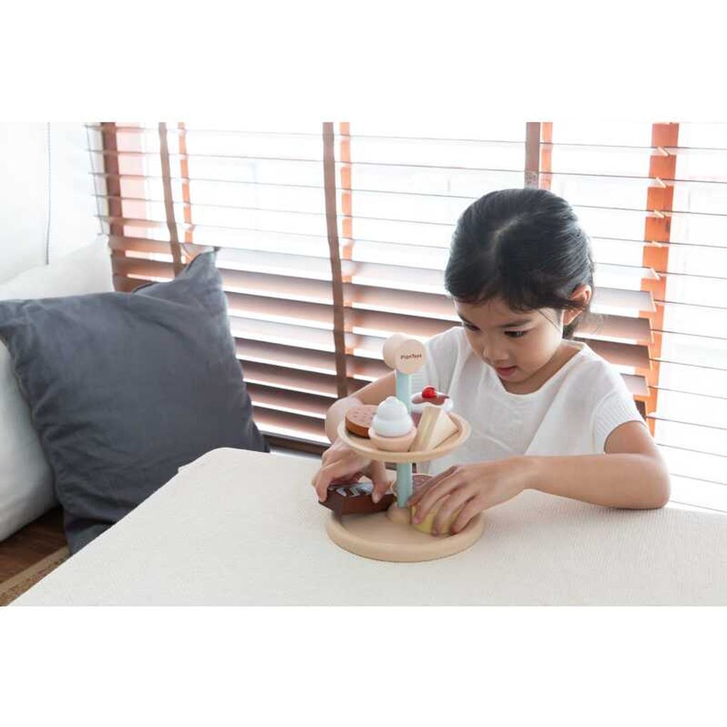 Kid playing PlanToys Bakery Stand Set