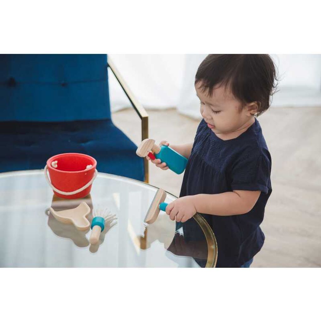 Kid playing PlanToys Cleaning Set
