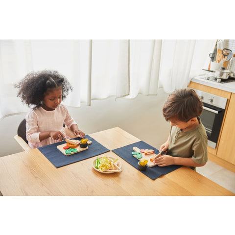 Kid playing PlanToys Steak Set