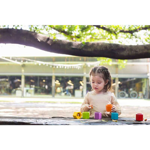 Kid playing PlanToys Beehives