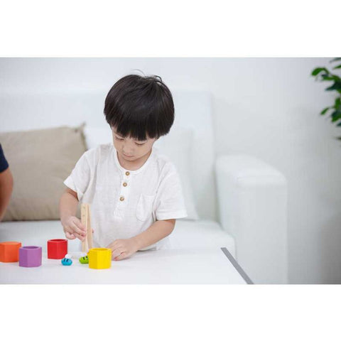 Kid playing PlanToys Beehives