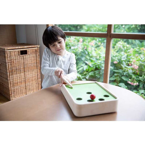 Kid playing PlanToys Ball Shoot Board Game