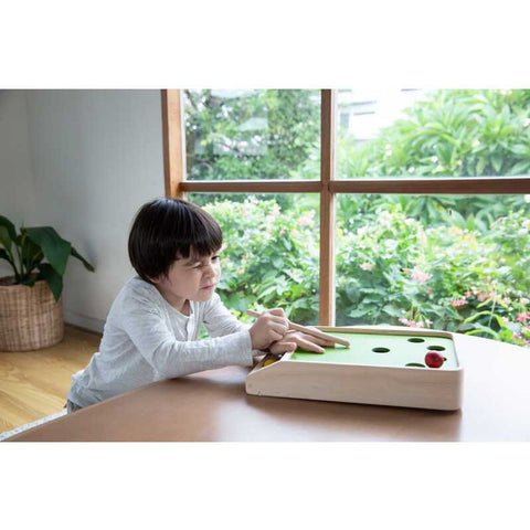 Kid playing PlanToys Ball Shoot Board Game