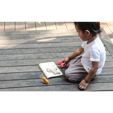 Kid playing PlanToys Dog Puzzle