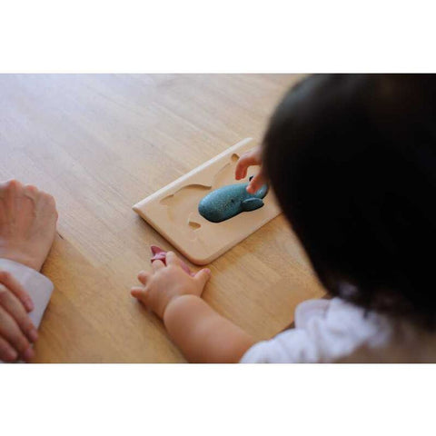 Kid playing PlanToys Sea Life Puzzle