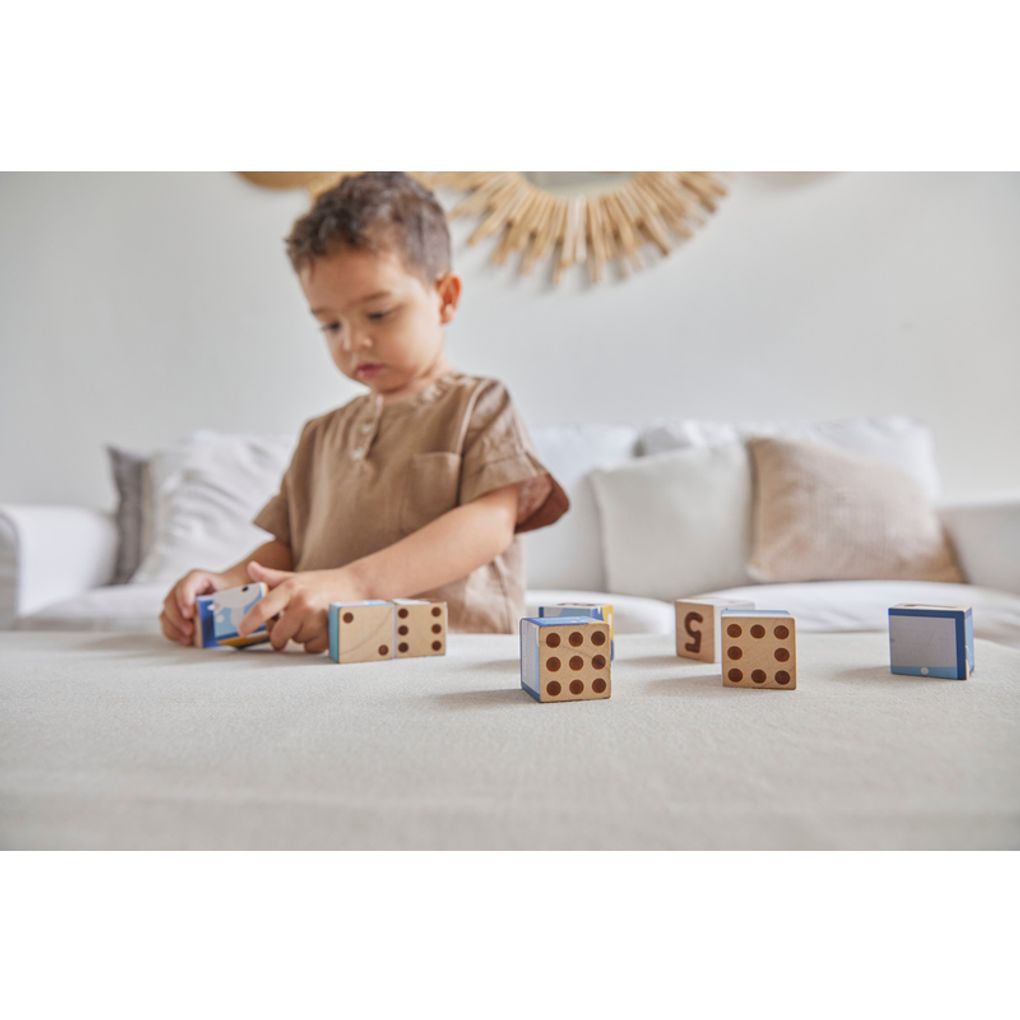 Kid playing PlanToys Animal Puzzle Cubes