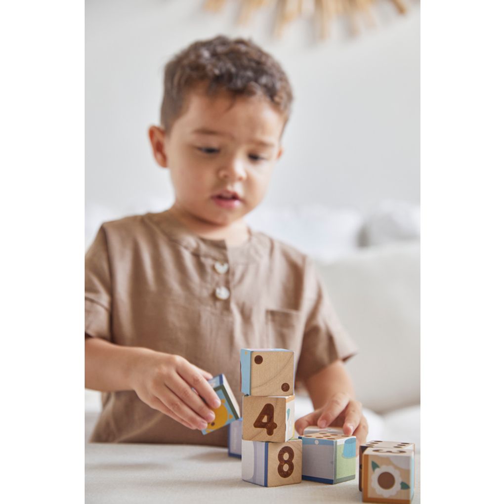 Kid playing PlanToys Animal Puzzle Cubes