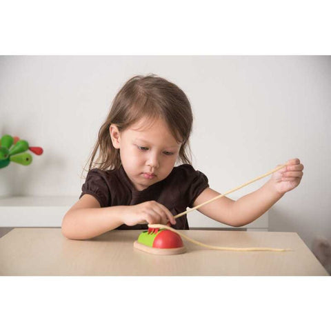 Kid playing PlanToys Tie Up Shoe