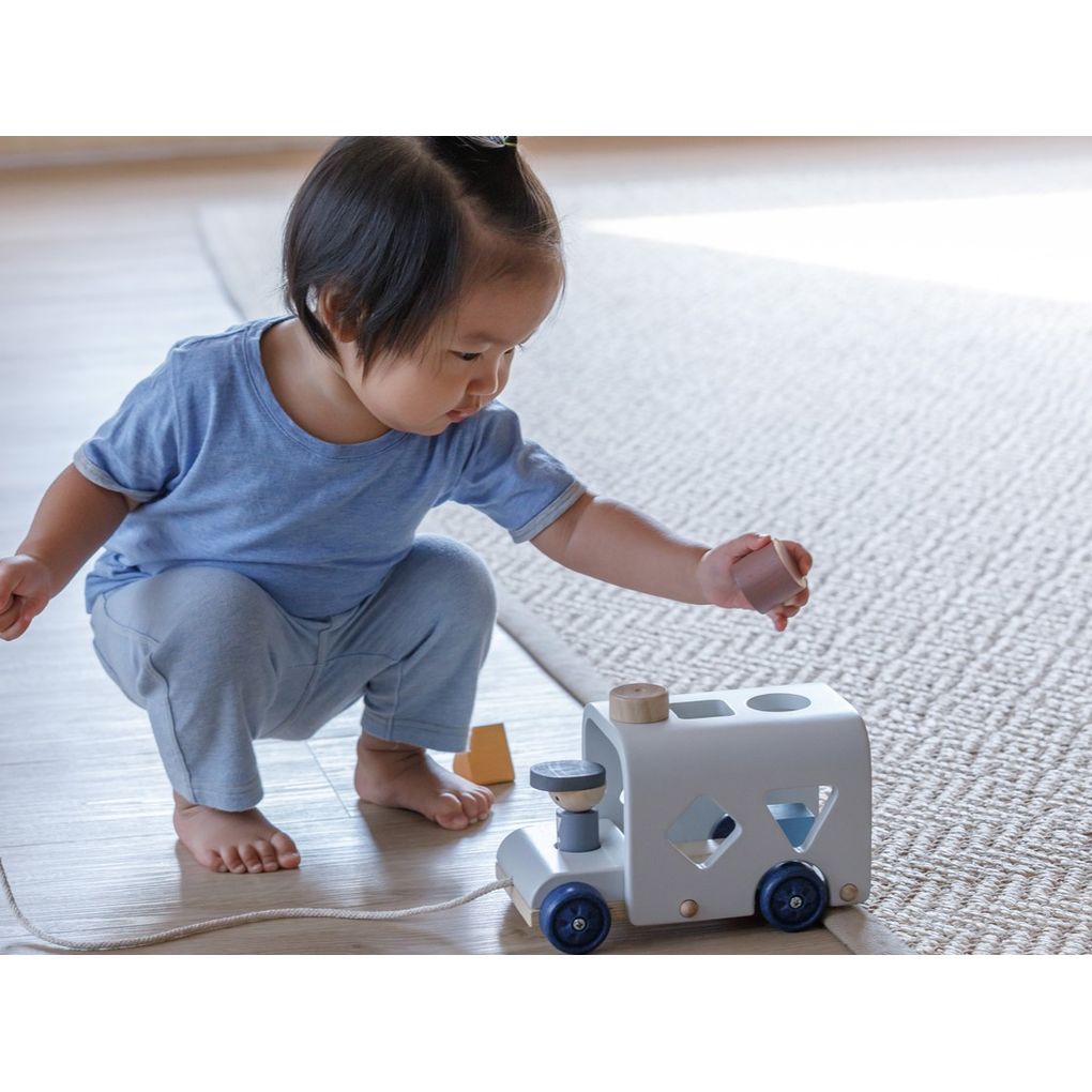 Kid playing PlanToys Sorting Bus - Orchard Series