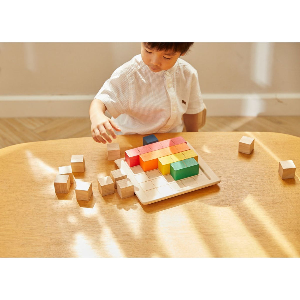 Kid playing PlanToys Colored Counting Blocks - Unit Plus