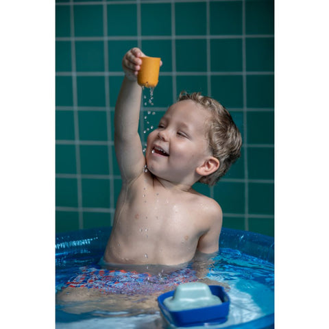 Kid playing PlanToys Tugboat