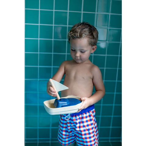 Kid playing PlanToys Sailboat