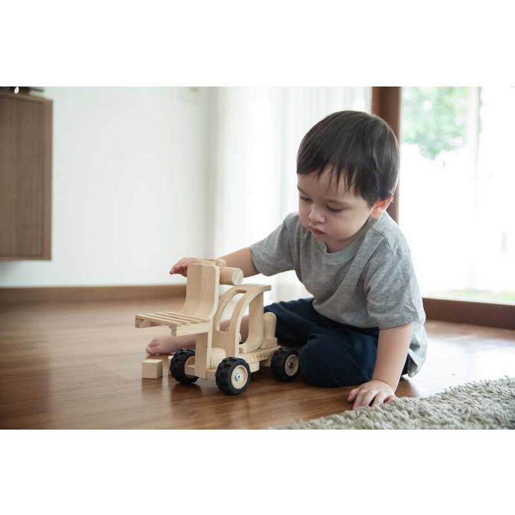 Kid playing PlanToys Forklift