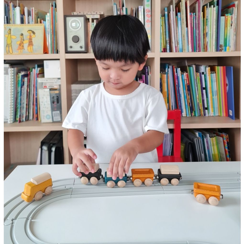 Kid playing PlanToys Classic Train