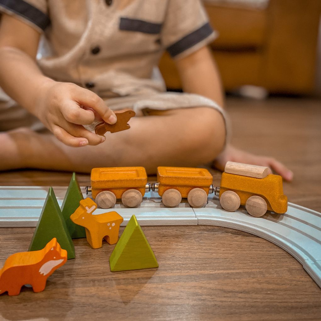 Kid playing PlanToys Cargo Train