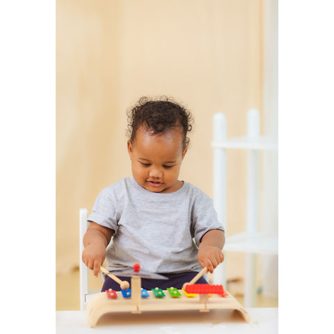 Kid playing PlanToys Musical Set