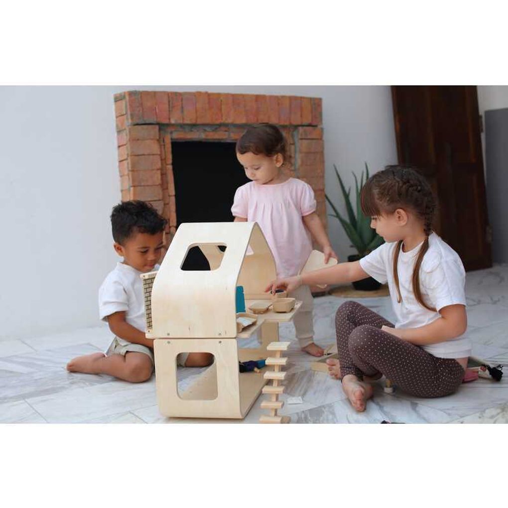 Kid playing PlanToys Contemporary Dollhouse