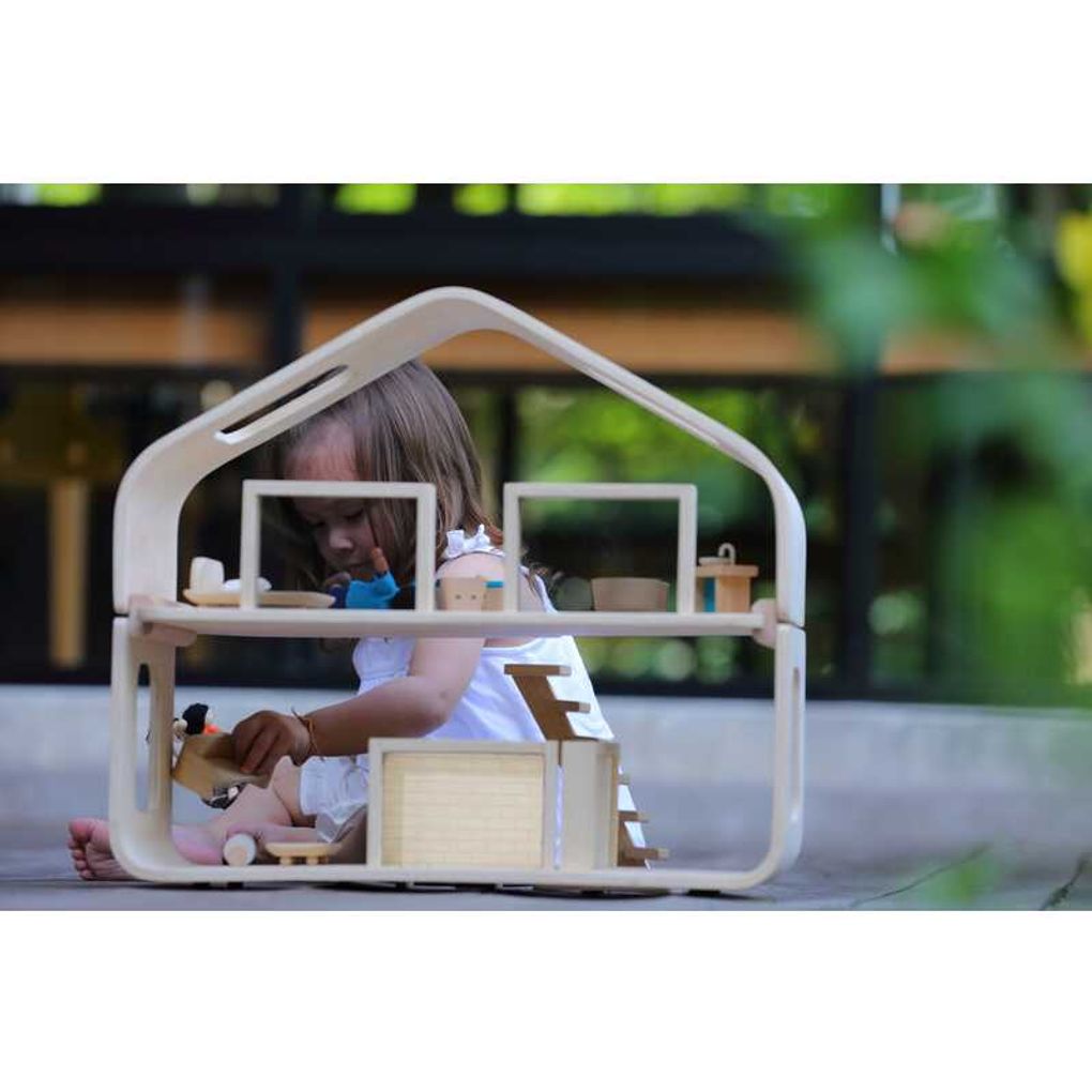 Kid playing PlanToys Contemporary Dollhouse